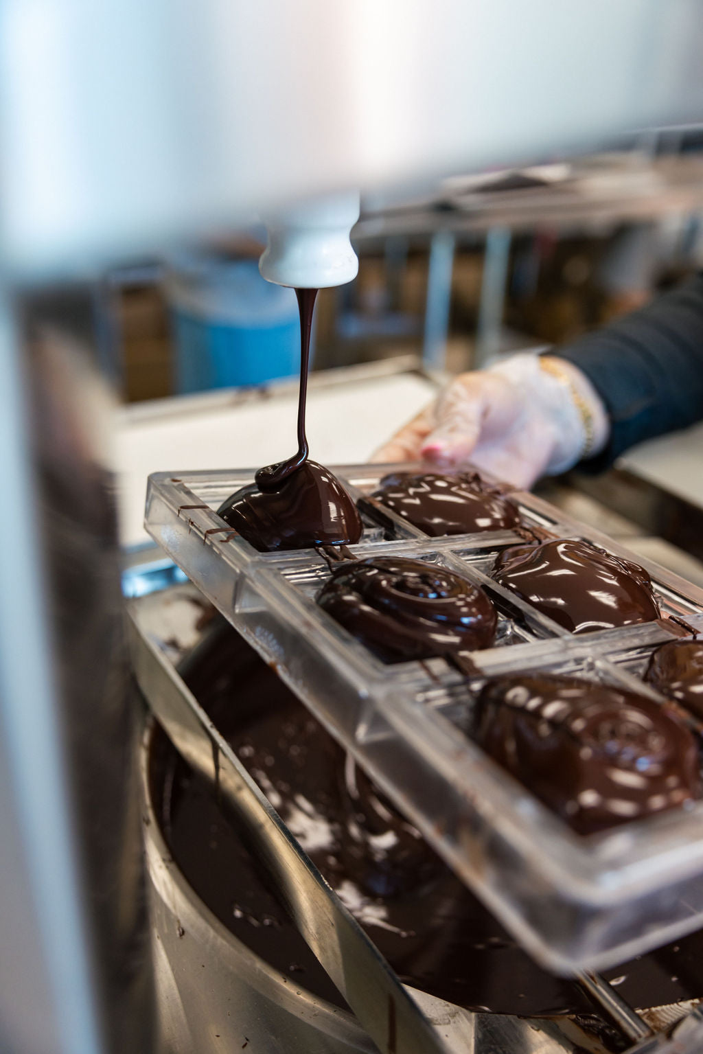 Chocolate being poured into molds at the Nibble factory