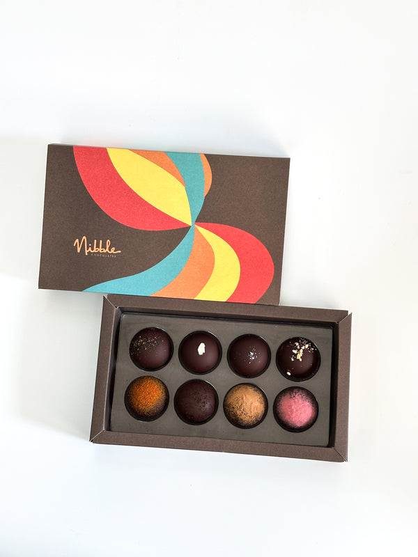 Front view of vegan organic chocolate truffle box with colorful packaging – Nibble Chocolate