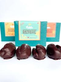 Assorted Nibble Chocolate gift boxes with open chocolate-covered dates in front