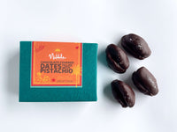 Orange Nibble Chocolate gift box with dark chocolate-covered dates beside it