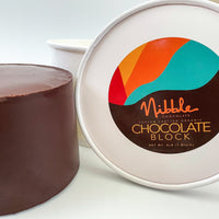 Close-up of Nibble Chocolate labeled bulk chocolate tub